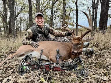 Brett Strouse, founder of STAT Outdoors, with a whitetail buck harvested with a compound bow